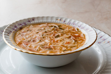 Turkish Traditional Vermicelli Soup in a wooden bowl / Tel sehriye corbasi.