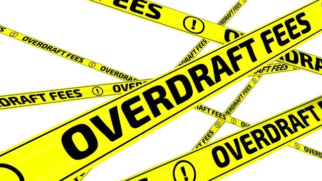Overdraft fees. Yellow warning tapes in motion