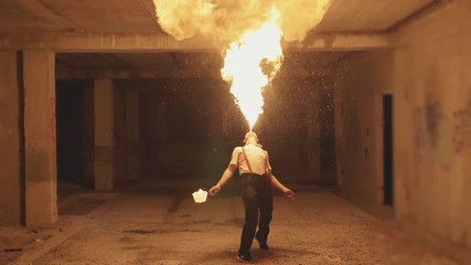 Fire show artist breathe fire in the dark, slow motion