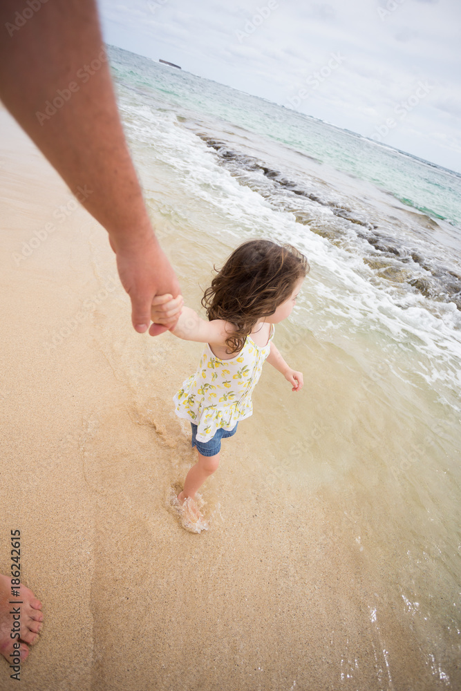 Wall mural child playing on beach in oahu hawaii