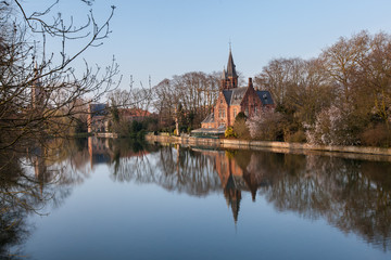 Medieval building (Castle) on Love lake, Minnewater Park in Bruges, Belgium