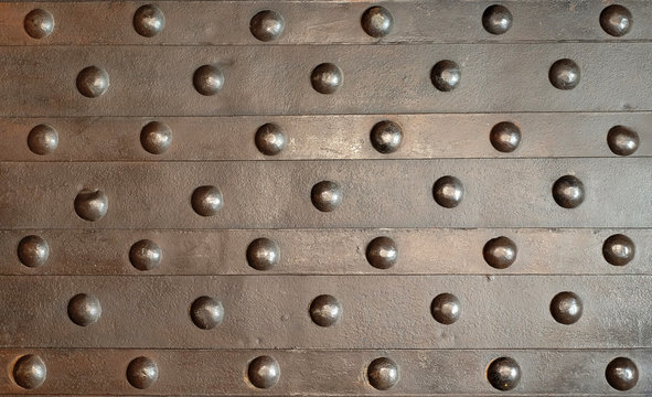 Background metal forged wall with rivets