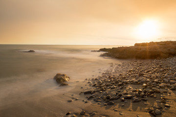 The calm sea in a very cloudy sunset