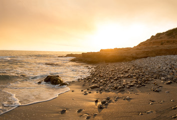 The calm sea in a very cloudy sunset