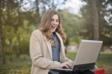 Excited girl using a laptop