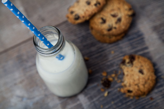 Small bottle of milk with Blue straw and cookies
