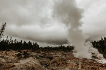 Smoke and Steam Rises in Barren landscape in Norris Geyser Basin