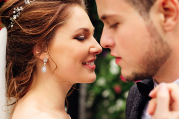 Fototapeta premium Close-up of a newlywed couple, a bride with a beautiful hair style and make-up