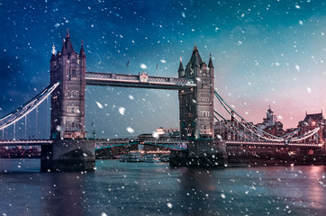 Fototapeta na wymiar Tower Bridge with falling snow during sunset, London, United Kingdom