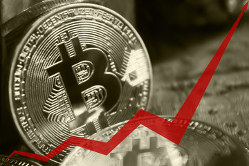 golden coins of bitcoins, the red arrow of the graph is directed upwards