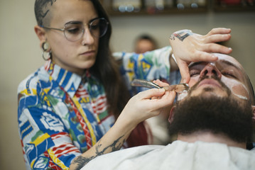 Woman Getting Beard Haircut With A Razor By Barber