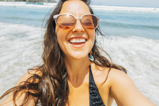 Happy Woman On Beach Taking Selfie Photo