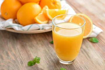 Obraz na płótnie Canvas Glass with delicious orange juice on table