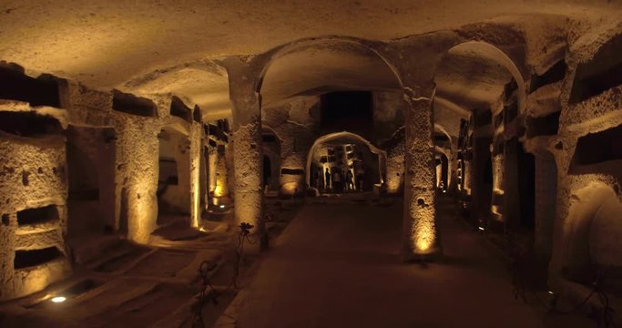 NAPLES, ITALY &ndash; JULY 2016 : Video shot in Catacombe di Napoli / Naples Catacombs with lights and people in view