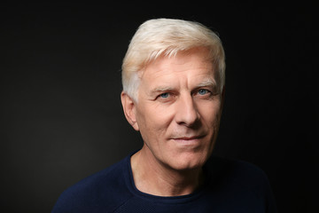 Obraz premium Portrait of handsome mature man on dark background