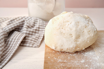 Raw puff pastry on wooden board