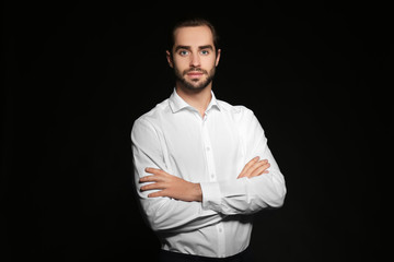 Young handsome man on black background