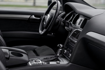 Fototapeta na wymiar Luxury car interior. Steering wheel, shift lever and dashboard.