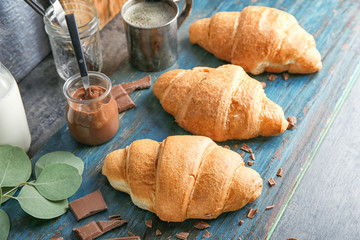 Yummy fresh croissants with chocolate on board