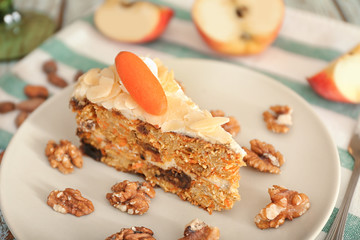 Piece of tasty carrot cake on table, closeup