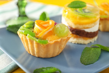 Plate with tasty sweet cakes, closeup