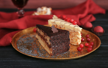 Tray with pieces of tasty cakes on table
