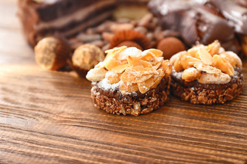 Tasty praline cakes on wooden background