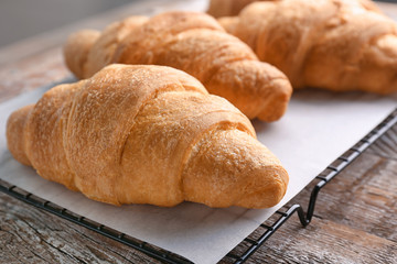 Fresh yummy croissants on table