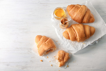 Fresh yummy croissants on wooden table