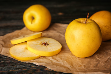 Ripe yellow apples on parchment, closeup