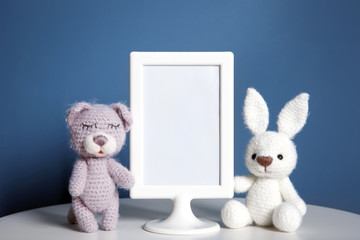 Mockup of blank frame with toys on color background