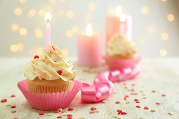 Birthday cupcake with candle on table against blurred background