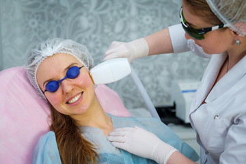 Young woman during the procedure in the clinic of aesthetic cosmetology