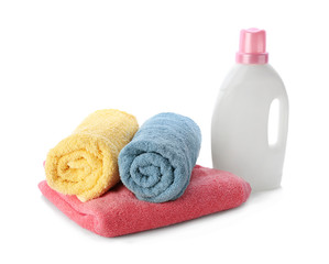 Obraz na płótnie Canvas Folded towels and laundry detergent on white background