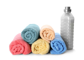 Obraz na płótnie Canvas Folded towels and laundry detergent on white background