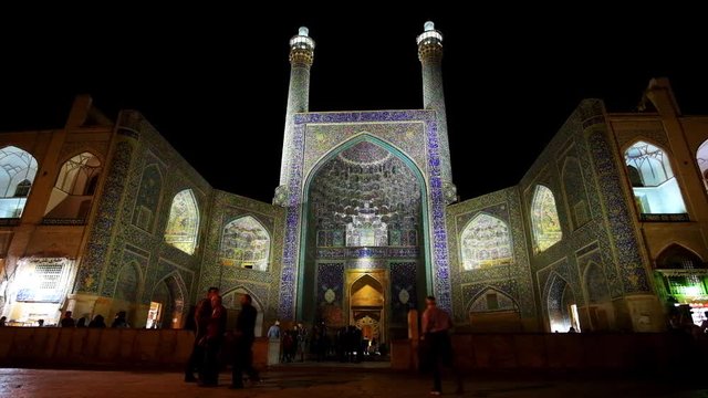The portal (iwan) of Shah Mosque (Royal or Imam Mosque), covered with fine patterns of glazed tiles and topped with two slender minaretrs, Isfahan, Iran