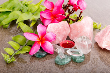 Pink Frangipani flowers and fern leaf with healing crystals