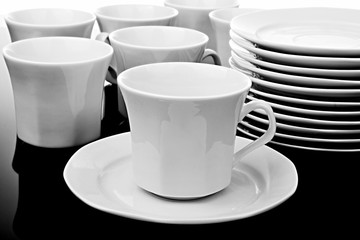 collection of cups and saucers all in white