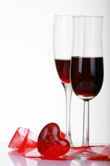 Valentine's Day with a bottle of wine with a rose and Valentin hart sitting on a reflated table top
