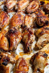 Chicken wings baked in a pan on white background isolated. Top flat, from above.