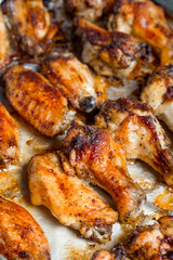 Chicken wings baked in a pan on white background isolated. Top flat, from above.