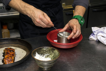 Obraz na płótnie Canvas Chef is putting rice in plate