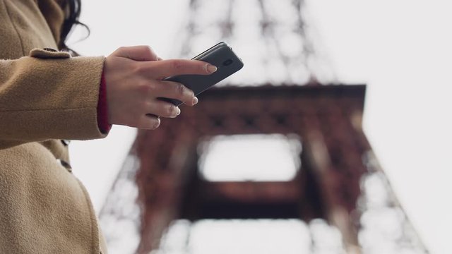 Lady looking for taxi number in smartphone app and calling to book vehicle