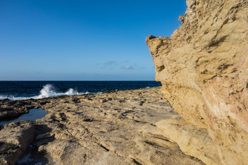 Rocky coastline and blue sky in Malta.