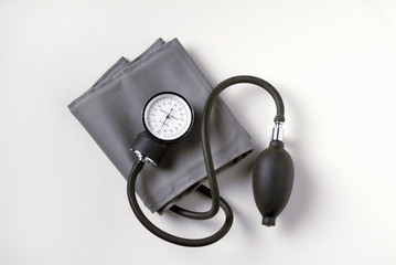 Blood Pressure Cuff on White Background.  Also known as a sphygmomanometer it is used to measure...