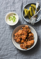 Deep fried chicken, pickles and mayonnaise, mustard sauce on a gray background, top view. Appetizer, snack table
