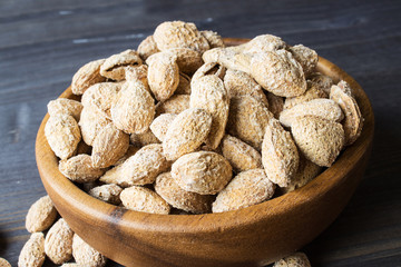 Salted almonds in the peel. A traditional snack for beer. Selective focus. Horizontal.