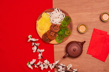 Conceptual flat lay Chinese New Year food and drink still life. Text appear in image: Prosperity, spring & good fortune.
