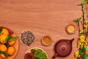 Flat lay Vietnamese new year food and drink on rustic red wooden table top. Text appear in image:...