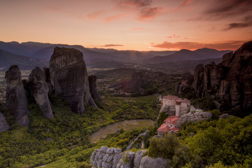 Amazing view of the Meteora site in Greece at sunset with one  monestry